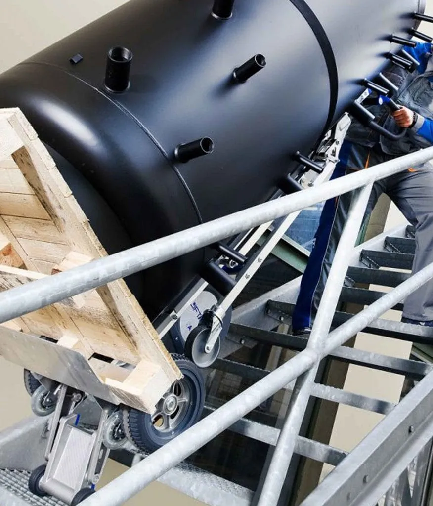 Powered stair climber taking a heavy load up a steel staircase