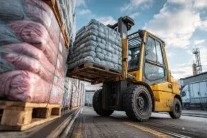 Forklift moving a load of goods.