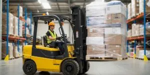 Forklift operator carrying a load on a forklift.